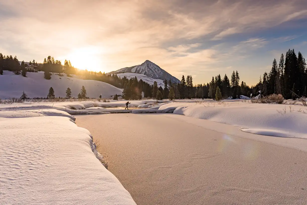 Cross-country skiing below Mt. Crested Butte at sunrise near Elk Mountain Lodge