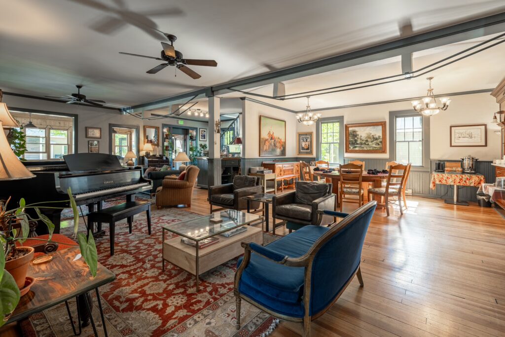 Historic lobby at Elk Mountain Lodge with a grand piano and hardwood floors in downtown Crested Butte, Colorado