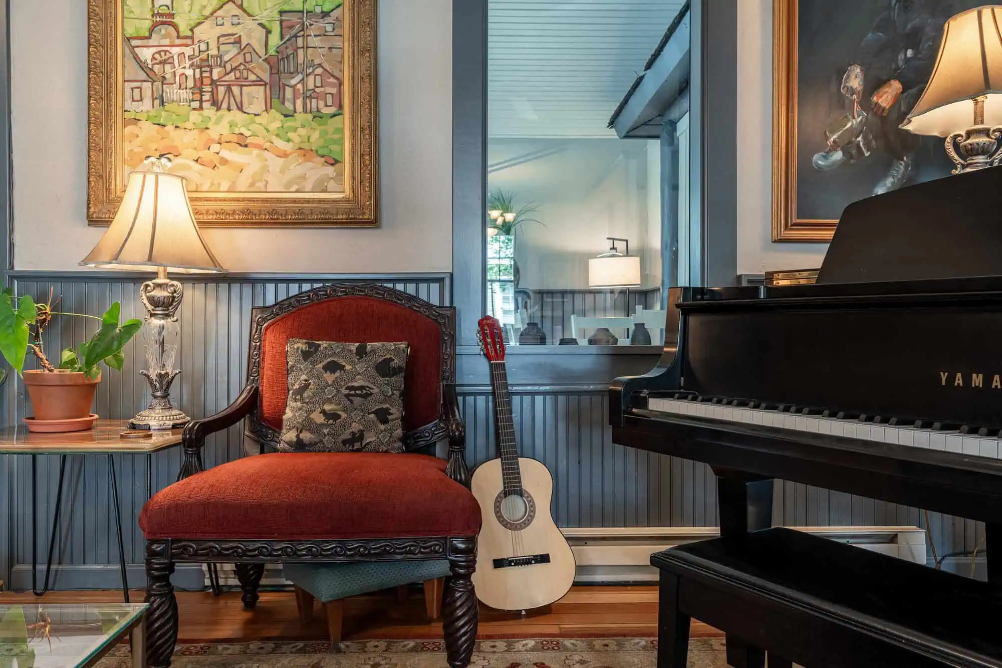 Lobby sitting area with grand piano and guitar at Elk Mountain Lodge in Crested Butte