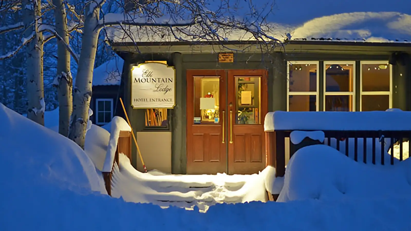 Elk Mountain Lodge hotel entrance on a snowy winter evening in Crested Butte, Colorado
